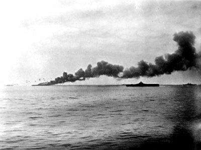 USS Bunker Hill (CV-17) burning and Randolph (CV-15) in May 1945