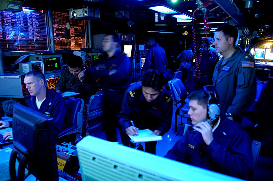 US Navy 071114-N-7883G-017 Lt. Cmdr. Abe Younce, top right, Lt.j.g. Eric Steidle and Lt. Gary Donley stand watch with liaison officers of the Japan Maritime Self-Defense Force (JMSDF)