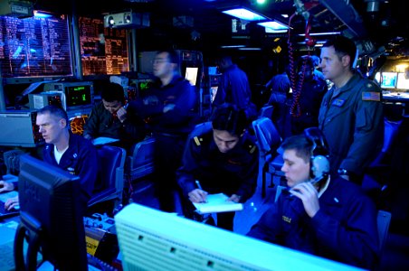 US Navy 071114-N-7883G-017 Lt. Cmdr. Abe Younce, top right, Lt.j.g. Eric Steidle and Lt. Gary Donley stand watch with liaison officers of the Japan Maritime Self-Defense Force (JMSDF)