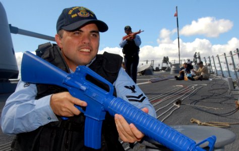 US Navy 071113-N-9758L-034 Storekeeper 2nd Class (SW) Gary Friday and Electronics Technician 1st Class (SW) Donny Faavi search for surface and air targets during a force protection training drill