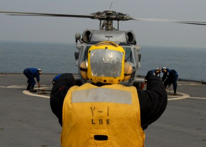 US Navy 071115-N-6710M-006 A MH-60 Seahawk lands on the flight deck of amphibious dock landing ship USS Tortuga (LSD 46) while conducting a personnel transfer in the vicinity of South Korea