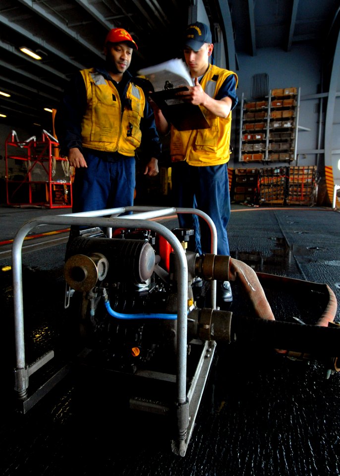 US Navy 071120-N-9898L-046 Damage Controlman 3rd Class Reginald Rose observes Damage Controlman Fireman Eugene Reyna as he goes through the list of procedures