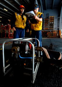 US Navy 071120-N-9898L-046 Damage Controlman 3rd Class Reginald Rose observes Damage Controlman Fireman Eugene Reyna as he goes through the list of procedures