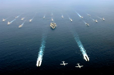 US Navy 071116-N-7883G-079 Two Japan Maritime Self-Defense Force (JMSDF) P-3C Orion patrol aircraft fly over a group of 19 American and Japanese naval ships at the end of ANNUALEX 19G, the maritime component of the U.S.-Japan e