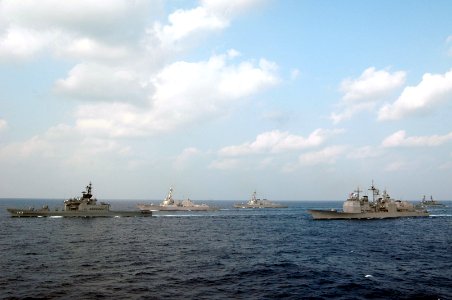 US Navy 071116-N-3136P-009 U.S. and Japan Maritime Self-Defense Force (JMSDF) ships line up in formation around the aircraft carrier USS Kitty Hawk (CV 63) at the end of exercise ANNUALEX 19G for a 19-ship group photo