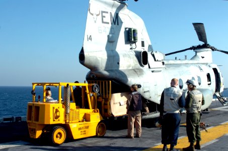 US Navy 071126-N-1831S-030 Sailors and Marines aboard the amphibious assault ship USS Kearsarge (LHD 3) help load crates of water onto a CH-46 Sea Knight helicopter for distribution in Bangladesh