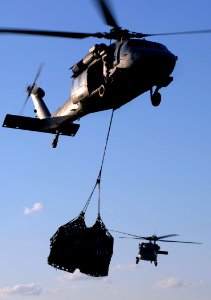 US Navy 071118-N-8923M-079 An SH-60 Seahawk, attached to the Sea Knights of Helicopter Sea Combat Squadron (HSC) 22, transports cargo from the Military Sealift Command fast combat support ship USNS Arctic (T-AOE 8)