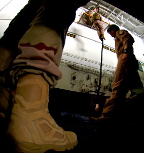 US Navy 071114-N-2984R-001 Sailors assigned to Explosive Ordnance Disposal Team (EOD) 6 perform a fast-rope exercise in the hangar bay aboard the Nimitz-class nuclear-powered aircraft carrier USS Harry S. Truman (CVN 75)