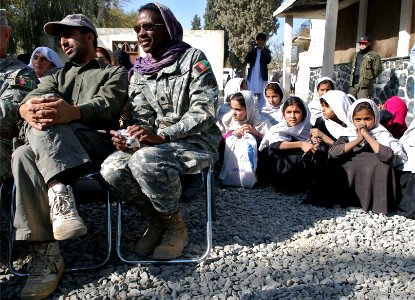 US Navy 071118-N-3385W-031 Cdr. Adrienne Simmons, watches a graduation ceremony for women who learned to raise bees and chickens as part of a women's empowerment program in the region