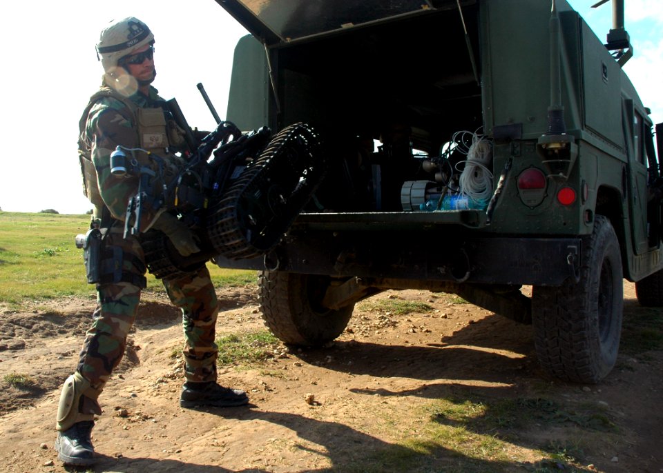 US Navy 071114-N-0577G-005 Chief Explosive Ordnance Disposal Technician Derrick A. Powell, assigned to Explosive Ordinance Disposal Mobile Unit (EODMU) 8, Det. 18, lifts a MK II Talon robot from the back of a high-mobility mult