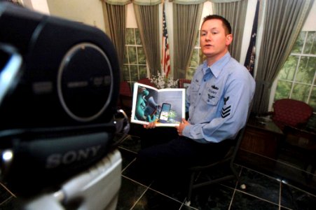 US Navy 071114-N-4879G-483 Hospital Corpsman 1st Class Sean Ehrsam, a medical laboratory technician aboard the nuclear-powered aircraft carrier USS Harry S. Truman (CVN 75), reads the Disney-Pixar book photo