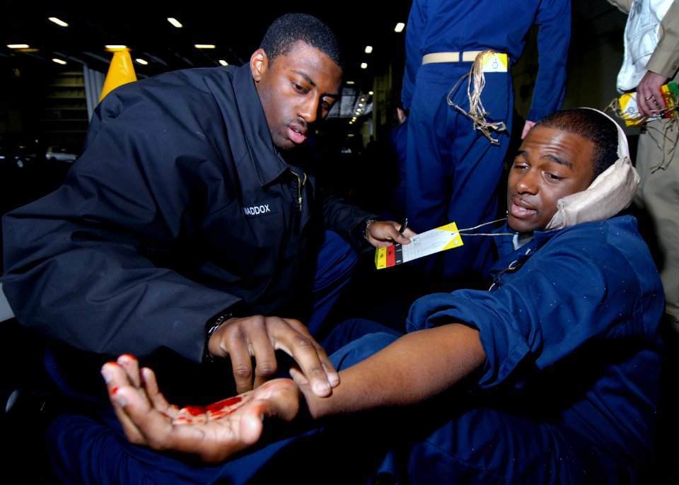 US Navy 071119-N-7981E-210 Hospital Corpsman 3rd Class Jeremy Maddox checks vital signs of a simulated casualty during a mass casualties drill in the hangar bay aboard the Nimitz-class nuclear-powered aircraft carrier USS Abrah