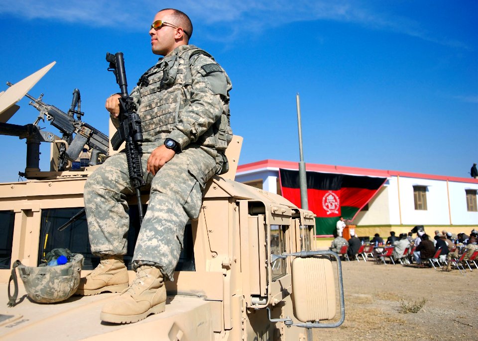 US Navy 071121-N-3385W-163 Aviation Electrician's Mate 1st Class Dave Burroughs, the assistant operations officer for Provincial Reconstruction Team Khost, stands guard during the opening ceremony for an agricultural demonstrat