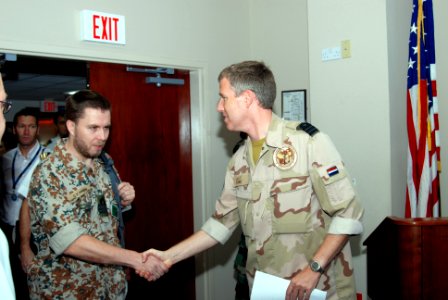 US Navy 071127-N-7095C-001 Cmdr. Wilco A. Kramer, Combined Maritime Forces (CMF) senior national representative for Netherlands Navy, welcomes Danish Navy Cmdr. Clemens Vest Hansen to the CMF boarding conference at U.S. Naval F