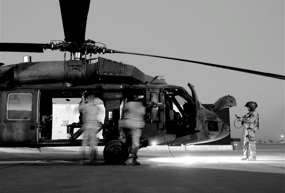 US Navy 071117-N-9643K-001 The crew of a Blackhawk helicopter perform their pre-flight checks before a mission delivering passengers to various locations in northern Iraq