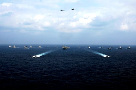 US Navy 071116-N-6106R-157 Two Japan Maritime Self-Defense Force (JMSDF) P-3C Orion patrol aircraft fly over a group of 19 American and Japanese naval ships at the end of ANNUALEX 19G, the maritime component of the U.S.-Japan e