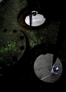 US Navy 071117-N-7981E-303 Aviation Boatswain's Mate (Equipment) Airman Austin Lewis, assigned to Air Department's V-2 Division, guides fresh arresting cable from the hangar bay aboard the Nimitz-class nuclear-powered aircraft