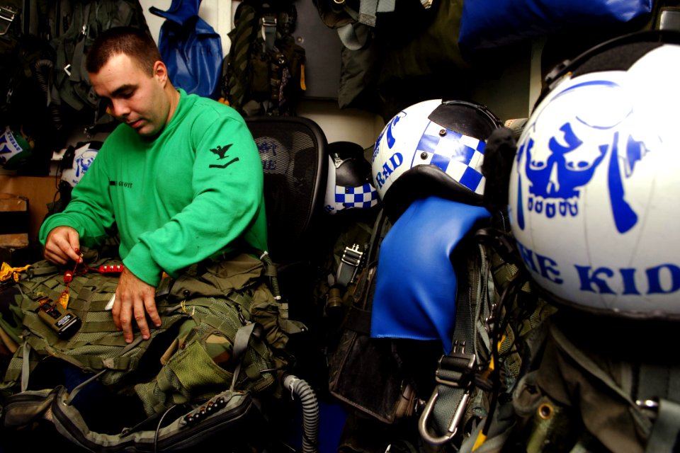 US Navy 071121-N-1598C-014 Aircrew Survival Equipmentman 3rd Class Mike Giannott, of Palm Harbor, Fla., conducts a 90-day inspection on a CMV-33 survival vest aboard the nuclear-powered aircraft carrier USS Enterprise (CVN 65)