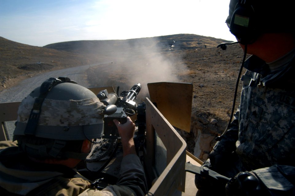 US Navy 071128-N-1810F-083 Chief Mass Communication Specialist Joe Kane fires a minigun during training at the firing range