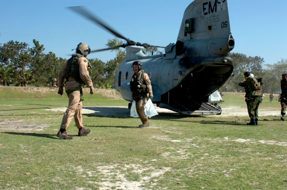 US Navy 071126-N-1831S-102 Marine pilots from a CH-46 Sea Knight helicopter, assigned to amphibious assault ship USS Kearsarge (LHD 3), help distribute purified water in Bangladesh