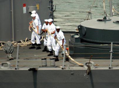 US Navy 071127-N-4965F-001 Sailors aboard the Oliver Hazard Perry-class guided-missile frigate USS Crommelin (FFG 37) heave in a mooring line as the ship prepares to depart Naval Station Pearl Harbor