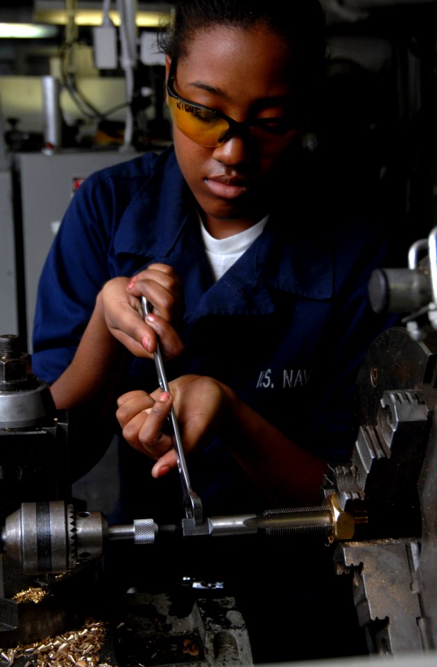 US Navy 071126-N-8923M-020 Machinery Repairman Fireman Domonique Roberson makes air conditioning bottle adapters in the machine shop aboard the Nimitz-class aircraft carrier USS Harry S. Truman (CVN 75)