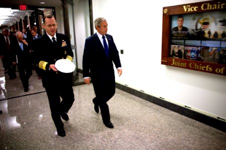US Navy 071129-N-0696M-109 Chairman of the Joint Chiefs of Staff, Adm. Mike Mullen escorts President George W. Bush through the Pentagon for a meeting with senior leaders discussing long-term strategic plans for the military
