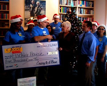 US Navy 071127-N-4163T-034 Local Wal-Mart store manager Casey O'Kane and fellow employees present Bell Esposito, manager of Naval Medical Center San Diego's (NMCSD) Fisher House, with a $5,000 donation from Wal-Mart Stores, Inc