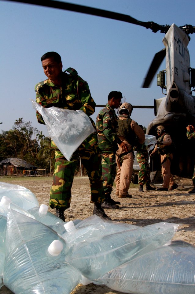 US Navy 071127-N-7955L-063 Marines with the 22nd Marine Expeditionary Unit (Special Operations Capable) and Bangladesh Army Soldiers offload bags of fresh water from a CH-46