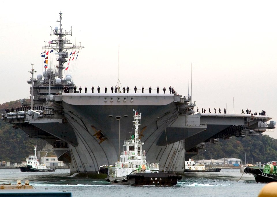 US Navy 071127-N-0483B-003 Sailors aboard the USS Kitty Hawk (CV 63) man the rails as the ship arrives in port