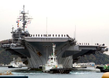 US Navy 071127-N-0483B-003 Sailors aboard the USS Kitty Hawk (CV 63) man the rails as the ship arrives in port