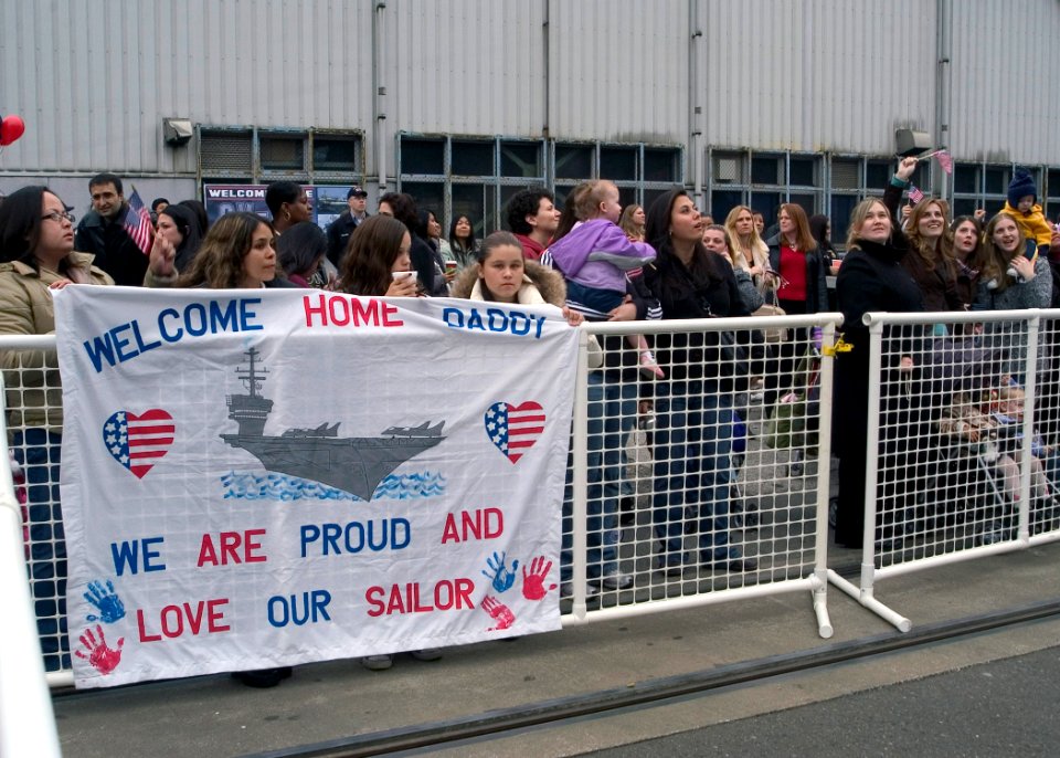 US Navy 071127-N-0483B-004 Family and friends celebrate the homecoming for USS Kitty Hawk (CV 63) as the ship arrives at Commander Fleet Activities Yokosuka