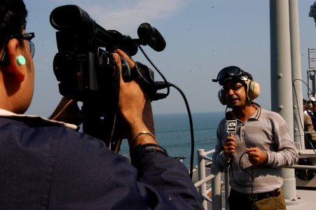 US Navy 071129-N-5642P-054 An international reporter is filmed reporting from the amphibious assault ship USS Kearsarge (LHD 3) on the unique capabilities that Kearsarge brings to the Bangladesh Humanitarian Assistance-Disaster photo