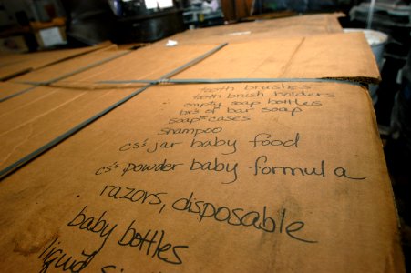 US Navy 071126-N-3173B-004 Pallets of water and hygiene supplies await transport in the hangar bay aboard the amphibious assault ship USS Kearsarge (LHD 3)