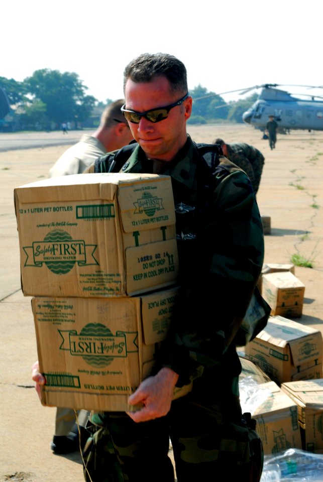 US Navy 071128-N-4010S-127 Chief Hospital Corpsman (FMF-SW-AW) Robert Ferrell, assigned to Fleet Surgical Team 7 aboard USS Essex (LHD 2), carries bottled water designated for Sailors working at Medical and Dental Community Act
