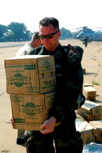 US Navy 071128-N-4010S-127 Chief Hospital Corpsman (FMF-SW-AW) Robert Ferrell, assigned to Fleet Surgical Team 7 aboard USS Essex (LHD 2), carries bottled water designated for Sailors working at Medical and Dental Community Act