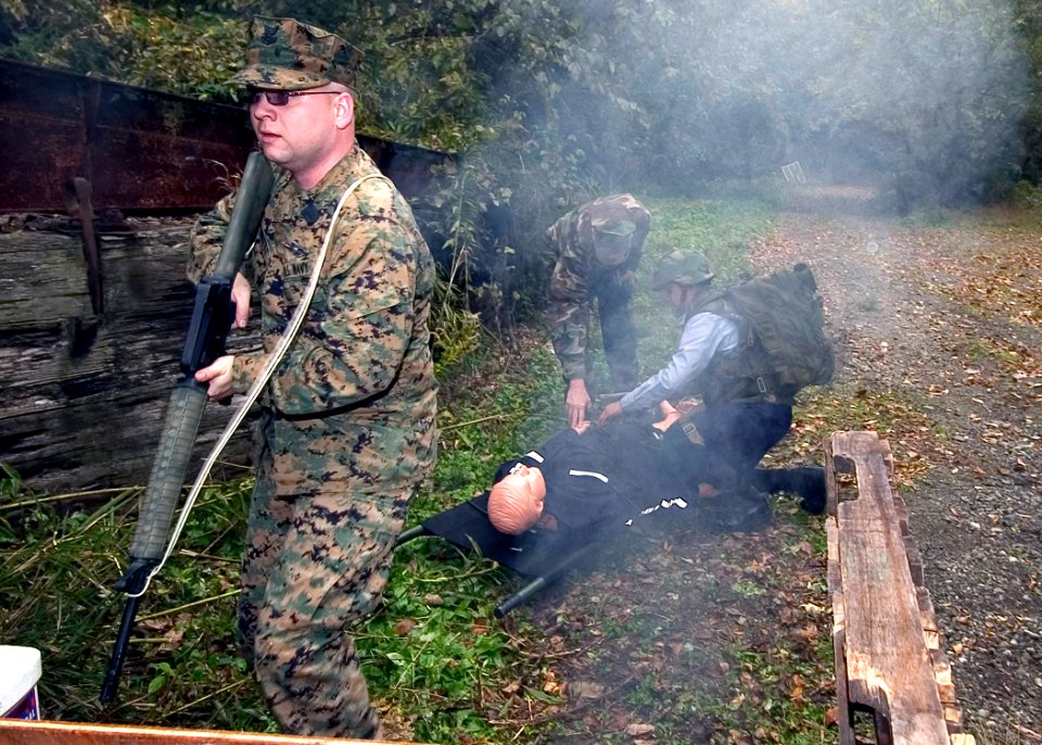 US Navy 071130-N-8534H-002 Hospital Corpsman 2nd Class Michael Bennett provides cover for the