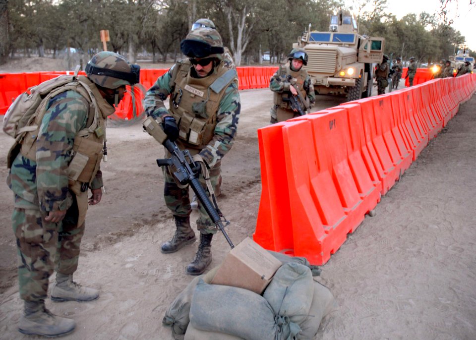US Navy 071201-N-0775Y-057 Construction Mechanic 2nd Class Maurice Wah attached to Naval Mobile Construction Battalion (NMCB) 3, conducts a weapons check as convoy security element returns