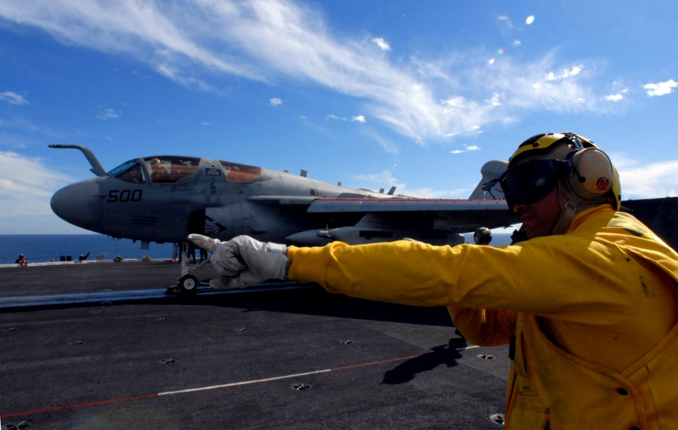 US Navy 071128-N-3659B-194 An Aviations Boatswain's Mate (handling) passes control of an EA-6B Prowler, assigned to the