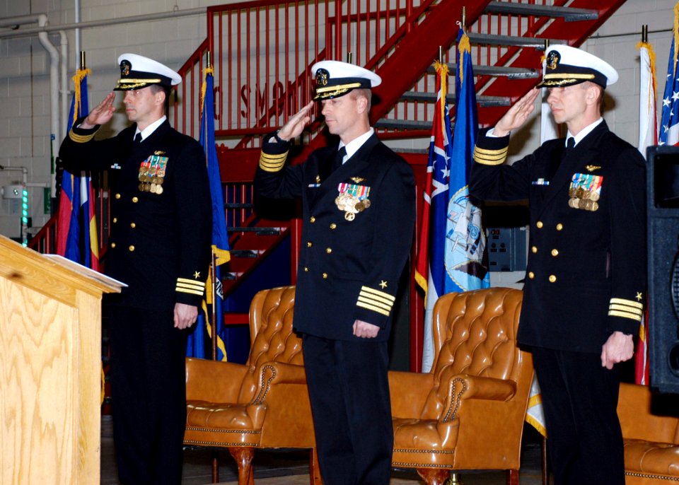 US Navy 071201-N-2716P-003 Cmdr. James Baca, left, Capt. Clay Tettelbach and Cmdr. Clark Schroeder salute during the parading of the colors during VAQ-129 SAU change of command