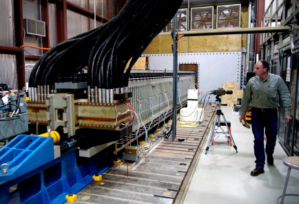 US Navy 071128-N-7676W-058 Jim Poyner, senior engineer, Gun Weapons Branch, Office of Naval Research performs a final inspection prior to the testing of the 32-megajoule Electro-Magnetic Laboratory Rail Gun laboratory launcher