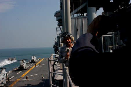 US Navy 071129-N-5642P-058 An international reporter is filmed reporting from the amphibious assault ship USS Kearsarge (LHD 3) on the unique capabilities that Kearsarge brings to the Bangladesh Humanitarian Assistance-Disaster photo