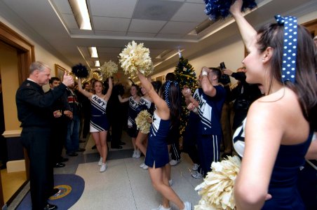 US Navy 071129-N-8273J-019 Chief of Naval Operations (CNO) Adm. Gary Roughead gives a thumbs up to U.S. Naval Academy cheerleaders and band performing during a pep rally in the Pentagon prior to the upcoming Army-Navy game photo