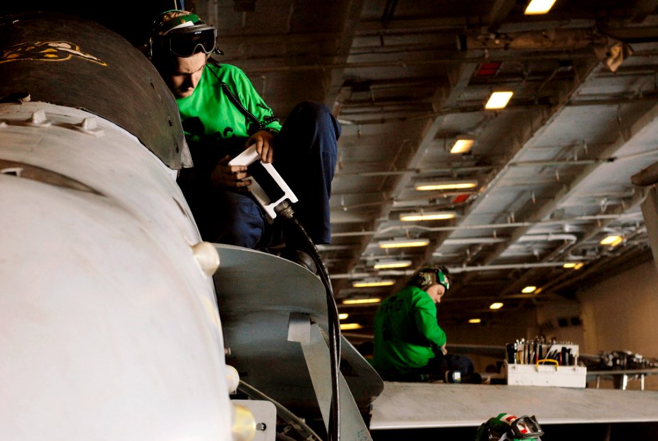 US Navy 071202-N-4776G-007 Aviation Support Equipment Technician 3rd Class David Merriam tests the electronics of an F-A-18C Hornet of Strike Fighter Squadron (VFA) 113