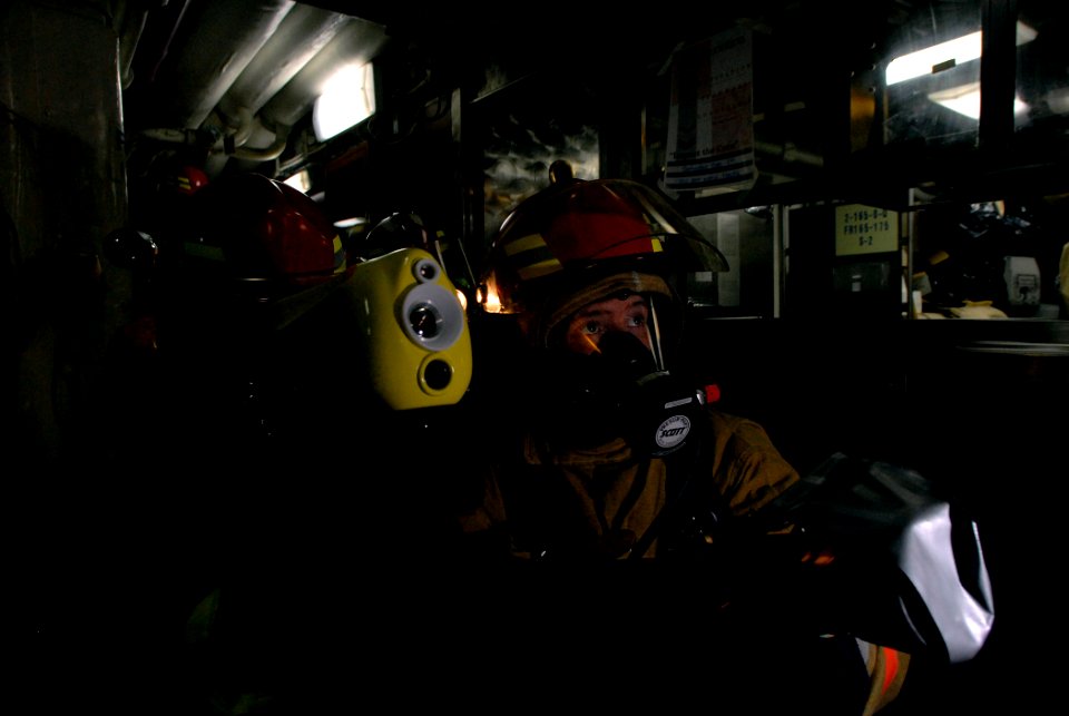 US Navy 071129-N-4776G-108 Electronics Technician 1st Class Andrew Johnson simulates hosing down a fire during a repair locker drill aboard the Nimitz-class nuclear-powered aircraft carrier USS Ronald Reagan (CVN 76)
