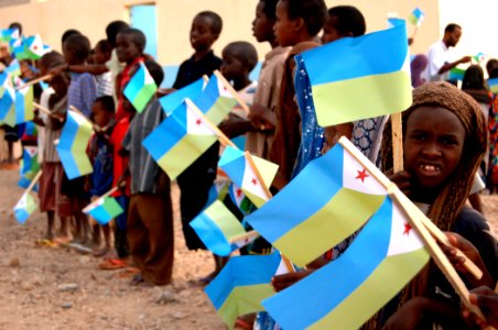 US Navy 071129-N-3285B-014 A young girl from the village of Assamo waves a flag prior to a dedication ceremony