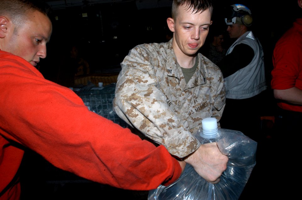 US Navy 071129-N-5642P-026 Sailors and Marines aboard the amphibious assault ship USS Kearsarge (LHD 3) pass bags of drinking water for distribution to the victims of Tropical Cyclone Sidr in Bangladesh