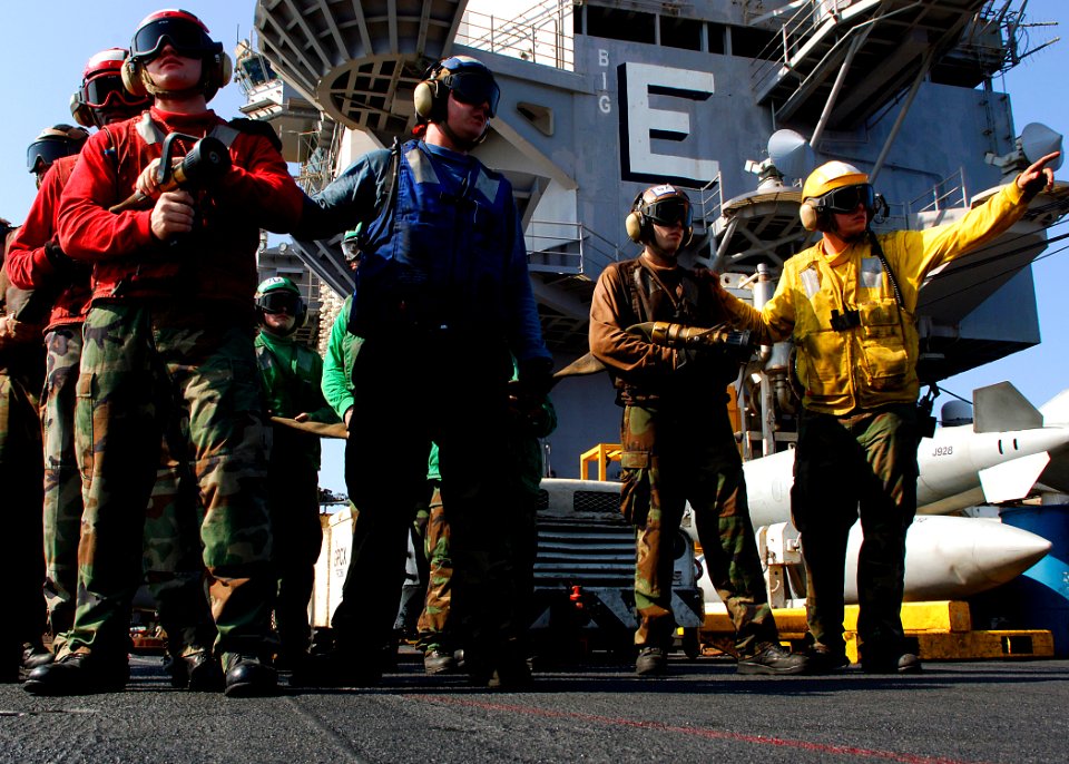 US Navy 071128-N-8132M-060 Sailors assigned to the No. 1 hose team fight a simulated fire during a general quarters drill on the flight deck of the nuclear-powered aircraft carrier USS Enterprise (CVN-65)