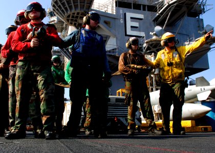 US Navy 071128-N-8132M-060 Sailors assigned to the No. 1 hose team fight a simulated fire during a general quarters drill on the flight deck of the nuclear-powered aircraft carrier USS Enterprise (CVN-65)