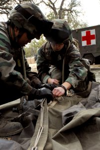 US Navy 071130-N-0775Y-006 Hospital Corpsman 2nd Class Cheryl Carreon and Construction Electrician 3rd Class Kashmir Kasper both attached to Naval Mobile Construction Battalion (NMCB) 3, assemble a tent to be used as female ber